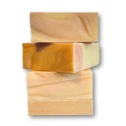 a stack of three bars of Mango Outpost soap by Brick Box